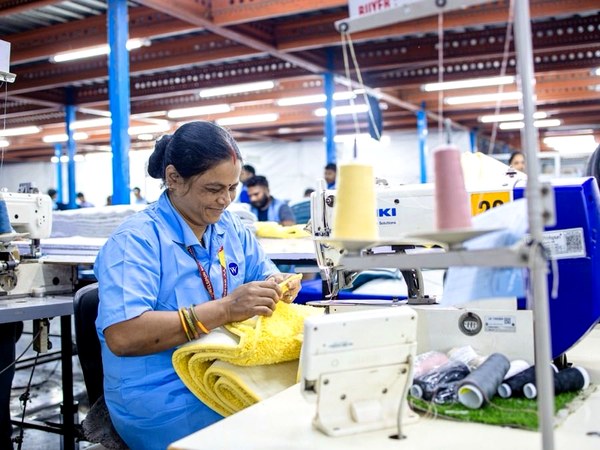 Machine operator sewing a garment on an industrial machine