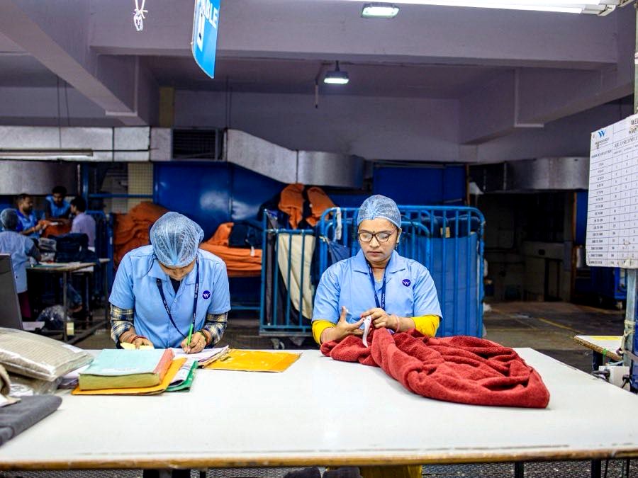 Factory workers sorting and bundling cut garment panels