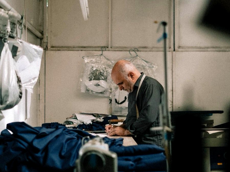 Garment technician working at an industrial sewing machine