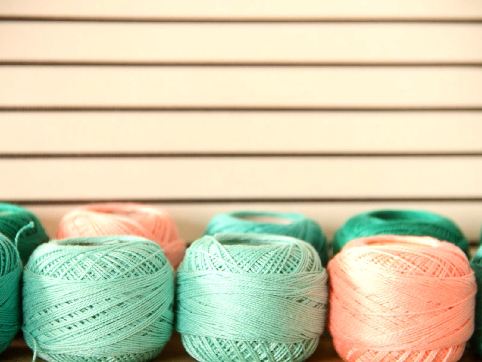 Cones of coloured yarn prepared for knitting